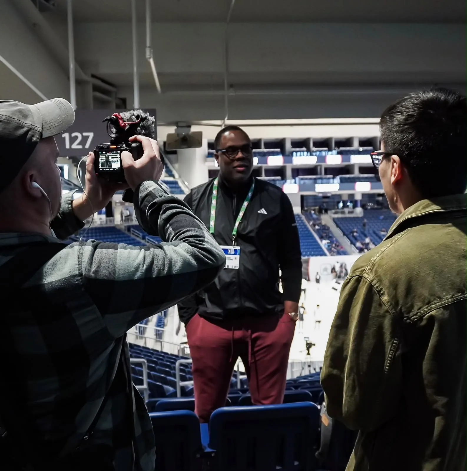 Roger Montgomery being interviewed inside a basketball arena